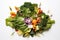 an aerial view of a salad with assorted leafy greens on white
