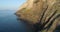 Aerial view of Salina coast. Huge cliff in a summer sunset. green bushes on mountain slope, little village in the valley