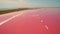 Aerial view of salt sea water evaporation ponds with pink plankton colour