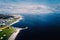 Aerial view, Salthill beach and Blackrock diving board, Tilt shift effect. Warm sunny day, People swimming in the ocean. Galway