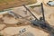 Aerial view of a sand factory with piles of sand and heavy machinery.