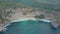 Aerial view of sandy beach with beautiful waves, turquoise ocean water, palms