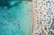 Aerial view of sandy beach with colorful umbrellas and blue sea