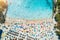 Aerial view of sandy beach with colorful umbrellas and sea