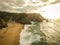 Aerial view from a sandy beach at the sunset with an amazing cliff