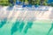 Aerial view of sandy beach with tourists swimming in beautiful clear sea water in Phuket, Thailand