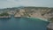 Aerial view of sandy beach and tropical island, blue ocean water and waves