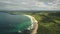 Aerial view sandy coastline, green grass meadows. Waves crashing out of shore Atlantic ocean bay