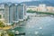 Aerial view of Sanya river and marina with many boats coming back and modern buildings in Sanya city Hainan China