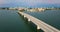 Aerial view of Sarasota city downtown at sunset with Ringling Bridge and high-rise office buildings on horizon. Real