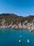 Aerial view of sardinia shoreline with boat and crystal clear blue turquoise sea - Cala Sirena  TRAVEL in SARDINIA