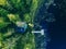 Aerial view of Sauna house by the lake shore.  Wooden pier with fishing boat