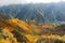 Aerial view of a scenic cable car flying over the autumn valley in the Tateyama Kurobe Alpine Route, Japan