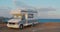 Aerial view. Scenic Sea. Modern Motorhome Rv on the Sea Coast. Concept Vacation on the Road. Timelapse.