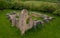 Aerial view about Schlossberg church ruins surrounded by forest.