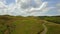 Aerial view of the scottish highlands with single track road and sheep