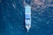 Aerial view of a SCUBA diving liveaboard in a clear, blue tropical ocean