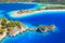 Aerial view of sea bay, rock, sandy beach, trees, mountain