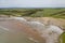Aerial view of sea cliffs, rock formations and a sandy beach Southerndown, Wales, UK