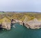 An aerial view from sea into an isolated rocky cove on the Pembrokeshire coast near to Tenby, South Wales