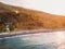 Aerial view of sea with mountains and local boats in Amed, Bali with sunset lights