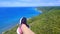 Aerial view of the sea and mountains from a paragliding flight