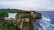 Aerial view of sea rocky coast with surf the waves, Bali, Indonesia, Pura Uluwatu cliff. Waves crushing rocky shore. Seascape,