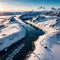 Aerial view of sea, snowy islands, mountains, road, blue sky at sunset in winter. Lofoten islands, Norway.