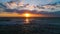 Aerial view of sea sunrise and beautiful cloudscape. Photographer with camera on the beach.