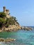 Aerial view of sea waves breaking beach with lloret de Mar castle