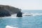 Aerial view of sea waves breaking rocky beach