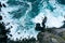 Aerial view of the sea waves crashing the rocky shore