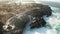 Aerial view of sea with waves crushing over Nusa Dua cliffs in Bali