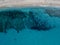 Aerial view of a seabed with rocks emerging from the sea, seabed seen from above, transparent water and beach