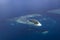 Aerial View from seaplane window over Atolls at Indian Ocean Maldives