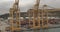 Aerial view. Seaport and loading docks at the port with cranes and multi-colored cargo containers.