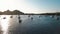 Aerial view on seashore of Lipari Island. Green trees and buildings. Mountains and sunrise. Yachts, catamarans and boats