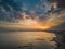 Aerial view of seaside cityscape of Porto Cesareo in Italy during bright cloudy sunset