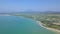 Aerial view seaside and sailing ships on parking lot near shore, city and mountain landscape. Drone view ship sailing in