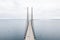 Aerial view of a self-anchored suspension bridge over a blue sea