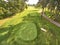 Aerial View of Serene Golf Course Greenery with Pathway and Mature Trees