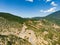 Aerial view of serpentine road snaking between mountains in West Greece. A road full of twists and turns winding sharply up the