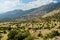 Aerial view of serpentine road snaking between mountains in West Greece. A road full of twists and turns winding sharply up the