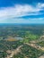 Aerial view of several golf courses in a densely forested urban development