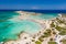 Aerial view of shallow sandy lagoons and a beach surrounded by deeper dark blue sea Elafonissi Beach