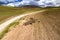 Aerial view of sheep flock traveling on a greenery alpine meadow at the Andes range.