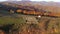 Aerial view of a sheepfold with herd of sheep inside in the mountains. Farmland in the autumn by drone