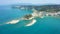 Aerial view of sheer white cliffs of Cape Drastis near Peroulades village