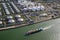 Aerial view of a ship pasing an oil storage silo terminal port