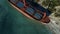 Aerial view of the ship washed ashore. Shot. Top view of an abandoned old and rusty shipwreck on a stormy day